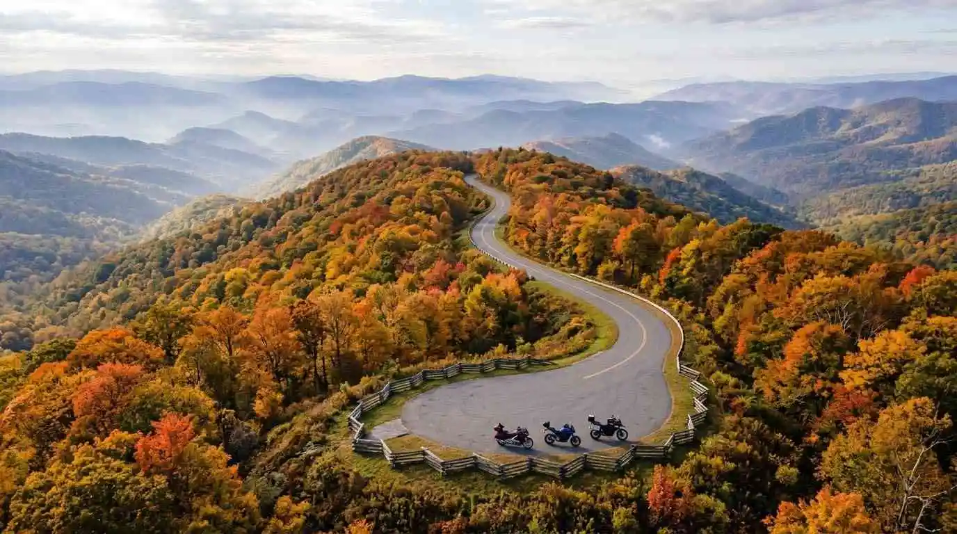 Aerial view of a scenic Blue Ridge Parkway overlook in autumn near Hillsville, Virginia with motorcycles parked below.
