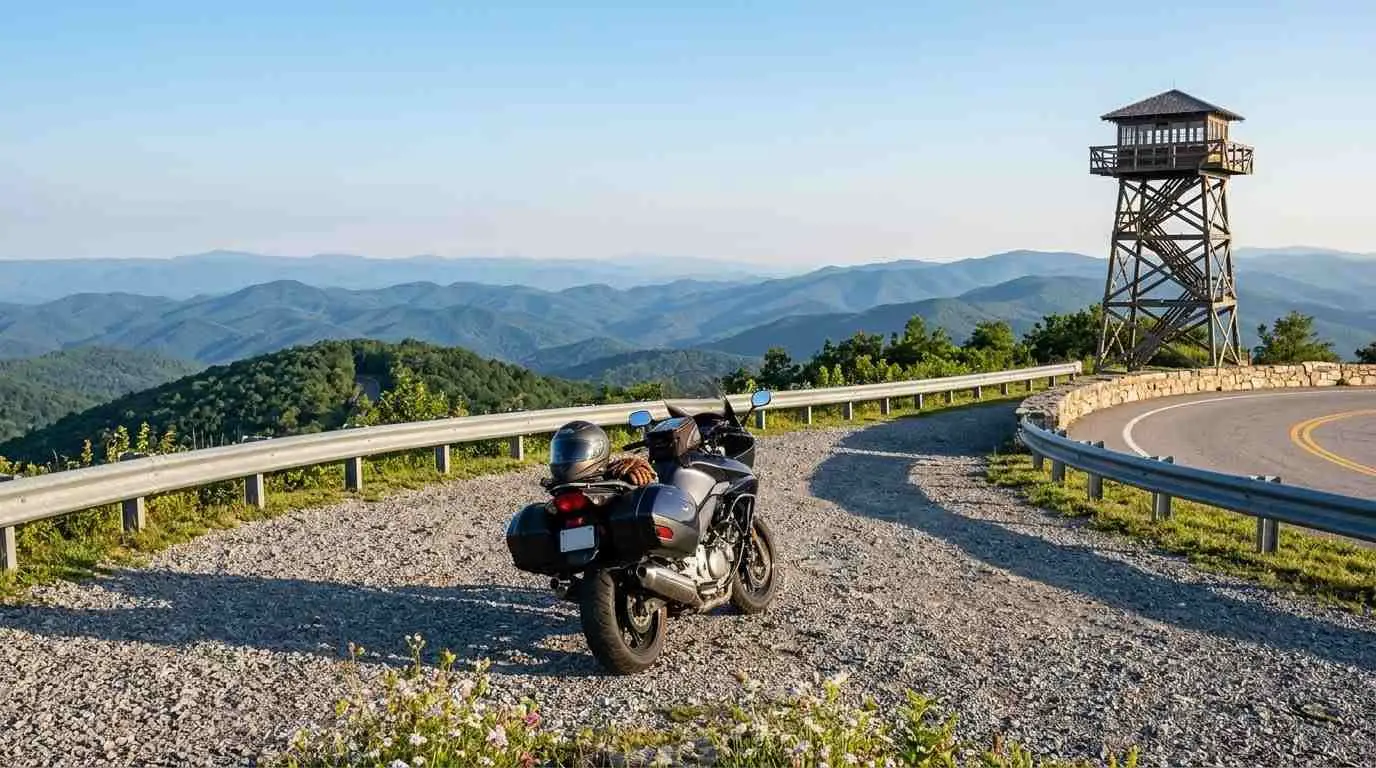 Touring motorcycle parked at a mountain overlook beside a wooden lookout tower near Wytheville, Virginia.